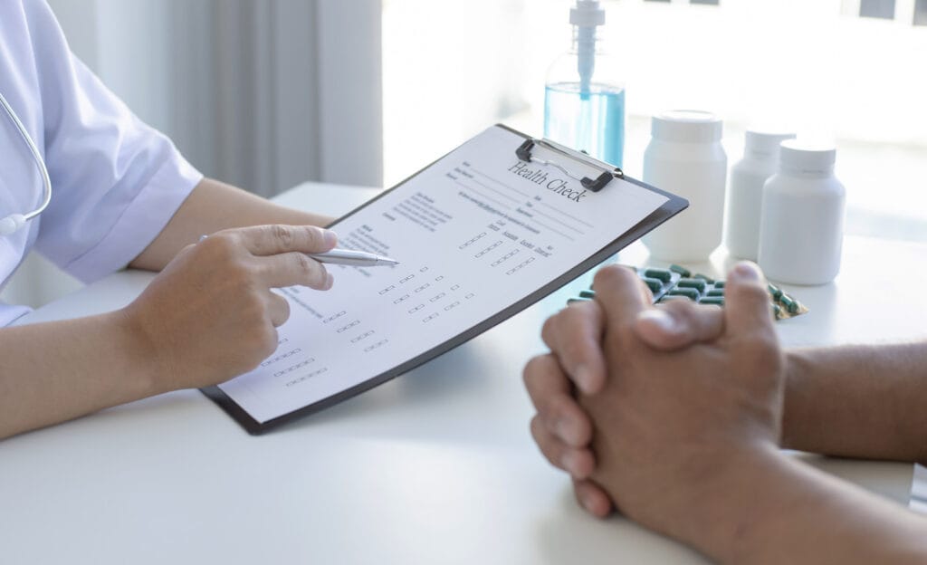 Does testosterone hurt your heart? Provider reviewing a health check chart with a patient